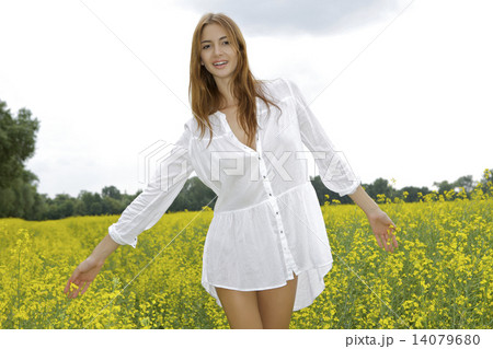brunette woman in a yellow flowers field 14079680