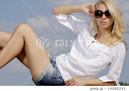 beautiful girl in sunglasses on background blue sky 14080241