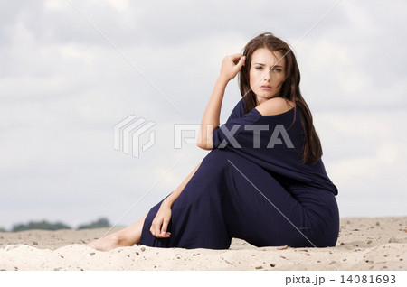 Sexy brunette posing in violet dress. 14081693