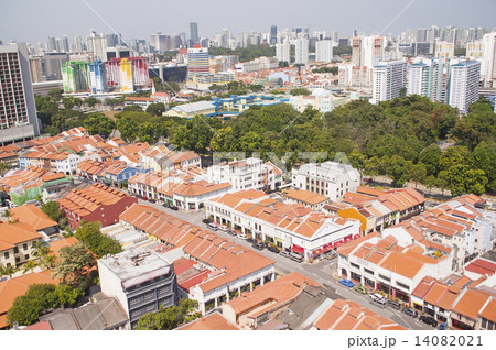 Singapore skyline and colonial shophouses with orange clay roof tiles. 14082021