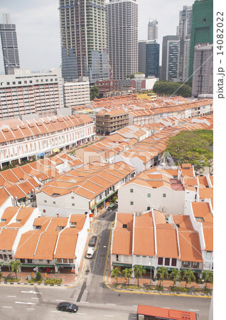 Singapore skyline and colonial shophouses with orange clay roof tiles. 14082022
