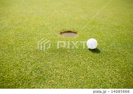 Golf ball near the hole 14085666