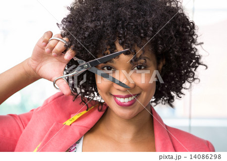 Female fashion designer holding scissors 14086298