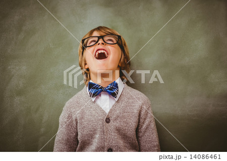 Boy laughing in front of blackboard 14086461