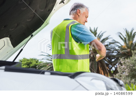 Man checking his watch after breaking down Man checking his watch after breaking down 14086599