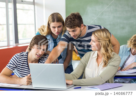 Students using laptop in classroom 14086777