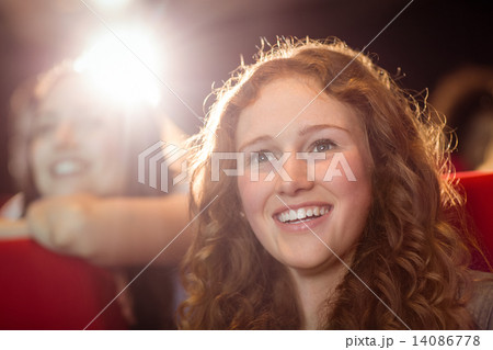 Young friends watching a film Young friends watching a film 14086778