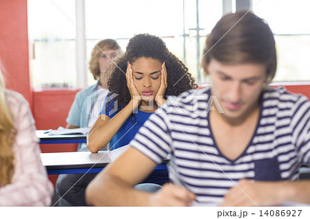 Thoughtful female student in classroom Thoughtful female student in classroom 14086927