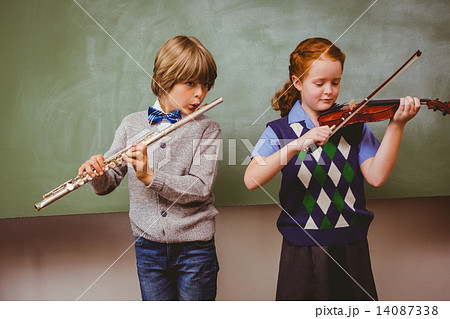 Students playing flute and violin in classroom Students playing flute and violin in classroom 14087338