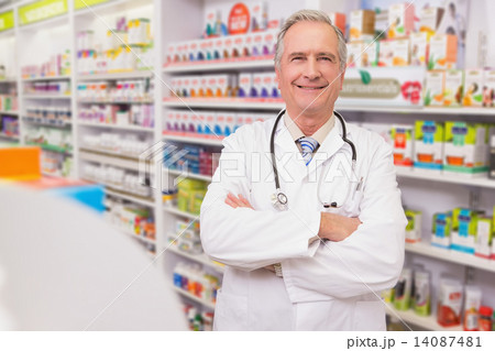 Smiling senior doctor with arms folded 14087481