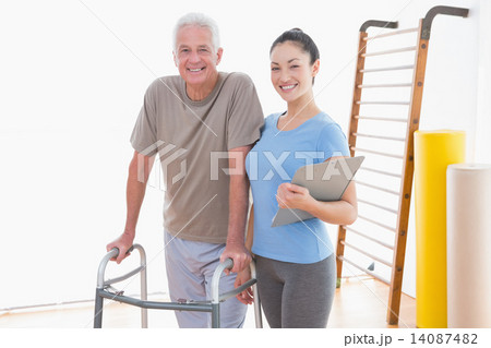 Senior man and his coach smiling at camera 14087482