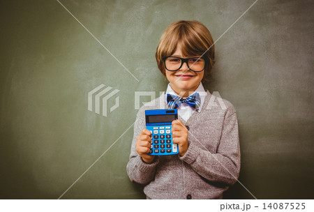 Portrait of cute little boy holding calculator Portrait of cute little boy holding calculator 14087525