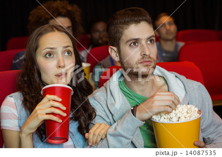 Young couple watching a film Young couple watching a film 14087535
