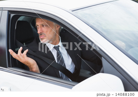 Perplexed businessman in the drivers seat Perplexed businessman in the drivers seat 14088100