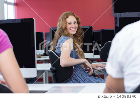 Student smiling at camera in computer class 14088340