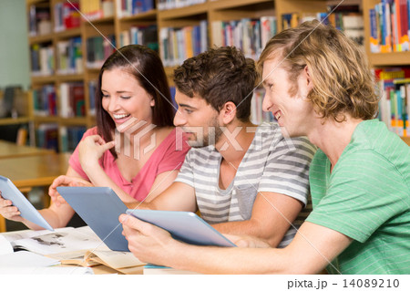 College students using digital tablets in library College students using digital tablets in library 14089210