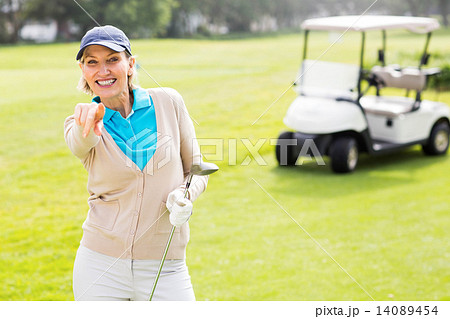 Female golfer smiling at camera Female golfer smiling at camera 14089454