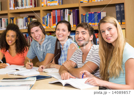 College students doing homework in library College students doing homework in library 14089857