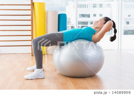 Woman exercising on fitness ball 14089909