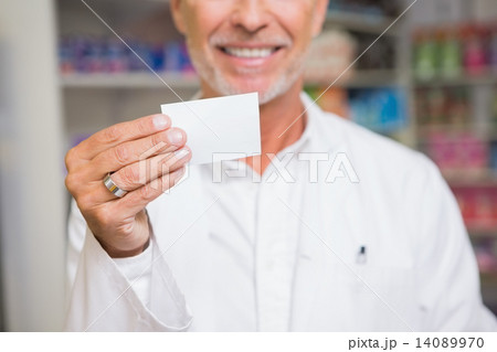 Senior pharmacist holding calling card 14089970