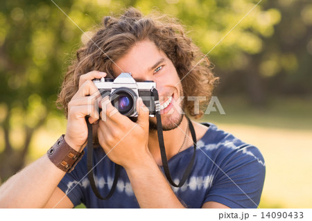 Handsome hipster using vintage camera Handsome hipster using vintage camera 14090433
