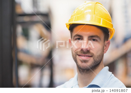 Close up of worker wearing hard hat in warehouse 14091807
