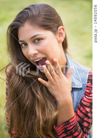 Pretty brunette smiling at camera 14092056