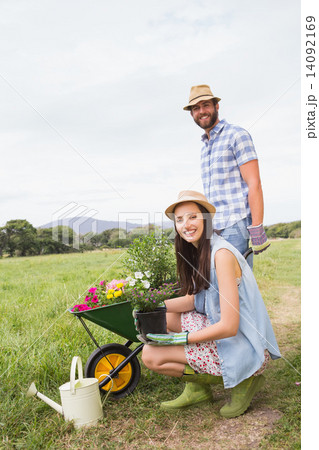 Happy young couple gardening together Happy young couple gardening together 14092169