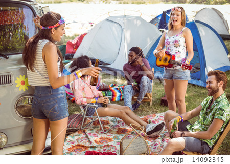 Hipsters having fun in their campsite Hipsters having fun in their campsite 14092345