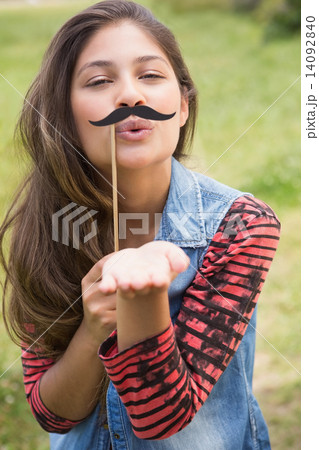Pretty brunette with fake mustache Pretty brunette with fake mustache 14092840