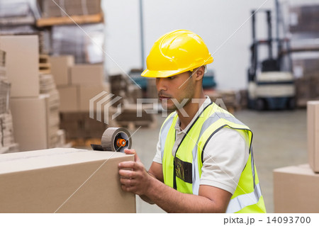 Worker preparing goods for dispatch Worker preparing goods for dispatch 14093700