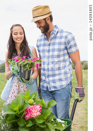 Happy young couple gardening together Happy young couple gardening together 14093805