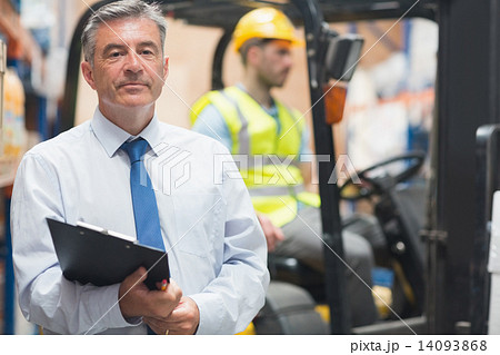 Manager posing in front of his employee 14093868