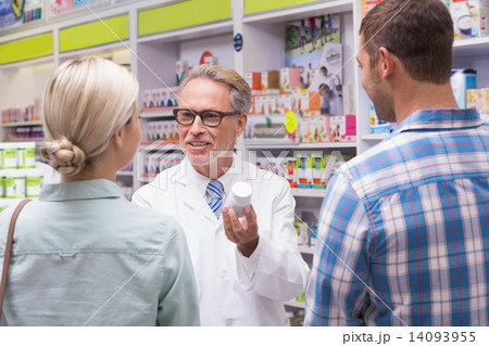 Senior pharmacist explaining the pills to patient Senior pharmacist explaining the pills to patient 14093955