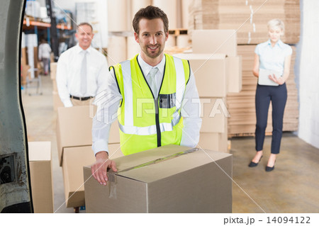 Delivery driver loading his van with boxes 14094122