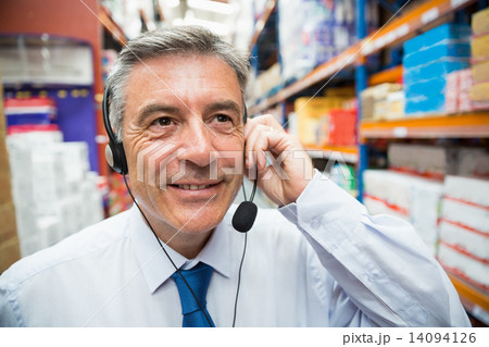 Warehouse manager giving orders on headset 14094126
