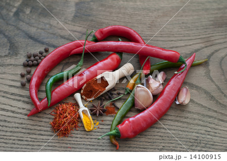 Red and Green Hot Peppers with Spices on Dark Wooden Background, 14100915