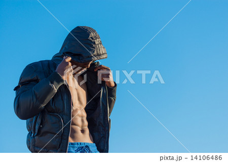 Muscular African black male wearing black bomber jacket hoodie with zipper, isolated with blue sky Muscular African black male wearing black bomber jacket hoodie with zipper, isolated with blue sky 14106486