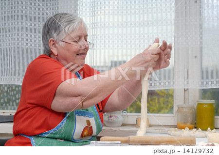 Elderly woman kneading dough Elderly woman kneading dough 14129732
