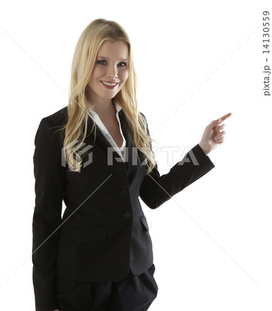 Beautiful young businesswoman pointing at white copyspace 14130559