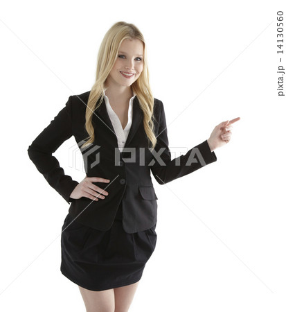 Beautiful young businesswoman pointing at white copyspace 14130560