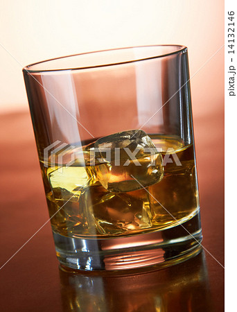 Whiskey with ice cubes on red Whiskey with ice cubes on red 14132146