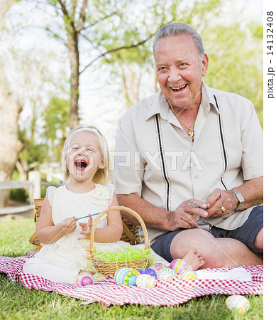 Grandfather and Granddaughter Coloring Easter Eggs on Blanket At Grandfather and Granddaughter Coloring Easter Eggs on Blanket At 14132408