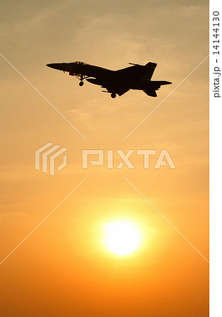 美しい夕日を背景に飛行する米海軍ＦＡ－１８Ｅスーパーホーネット艦上戦闘攻撃機 14144130