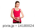 pretty fitness girl measuring her waist and smiling isolated 14180024