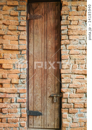 Tall door on the brick wall 14185940