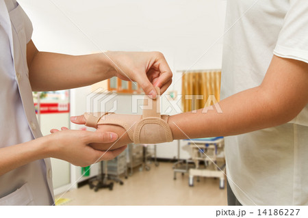 Physical therapist helps woman's patient wearing a wrist brace Physical therapist helps woman's patient wearing a wrist brace 14186227
