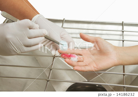 Medical assistant changes the dressing of a wound at the emergen 14186232