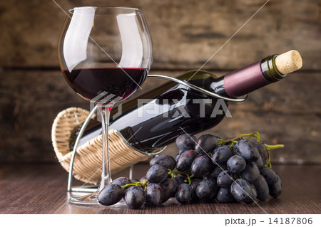Winery background. Wineglass with bottle of red wine and cluster of grape 14187806