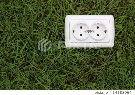 electric power receptacle on a green grass background 14188064